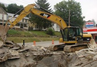 Excavator demolishing a property