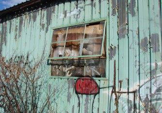 Broken window on a dilapidated property